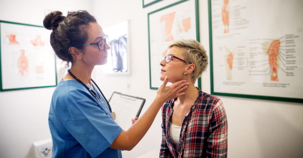 A woman consulting with a medical professional after an accident